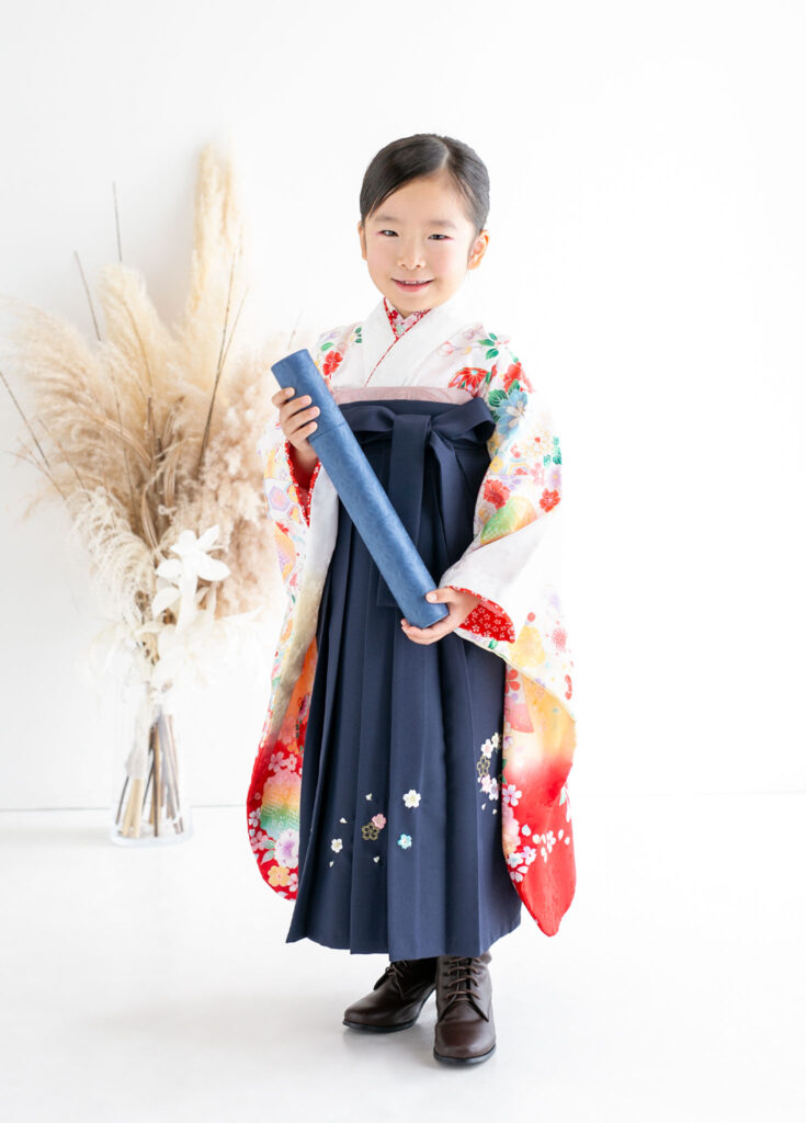 卒園：卒園証書を手に、ブーツを合わせた卒園袴を着た女の子