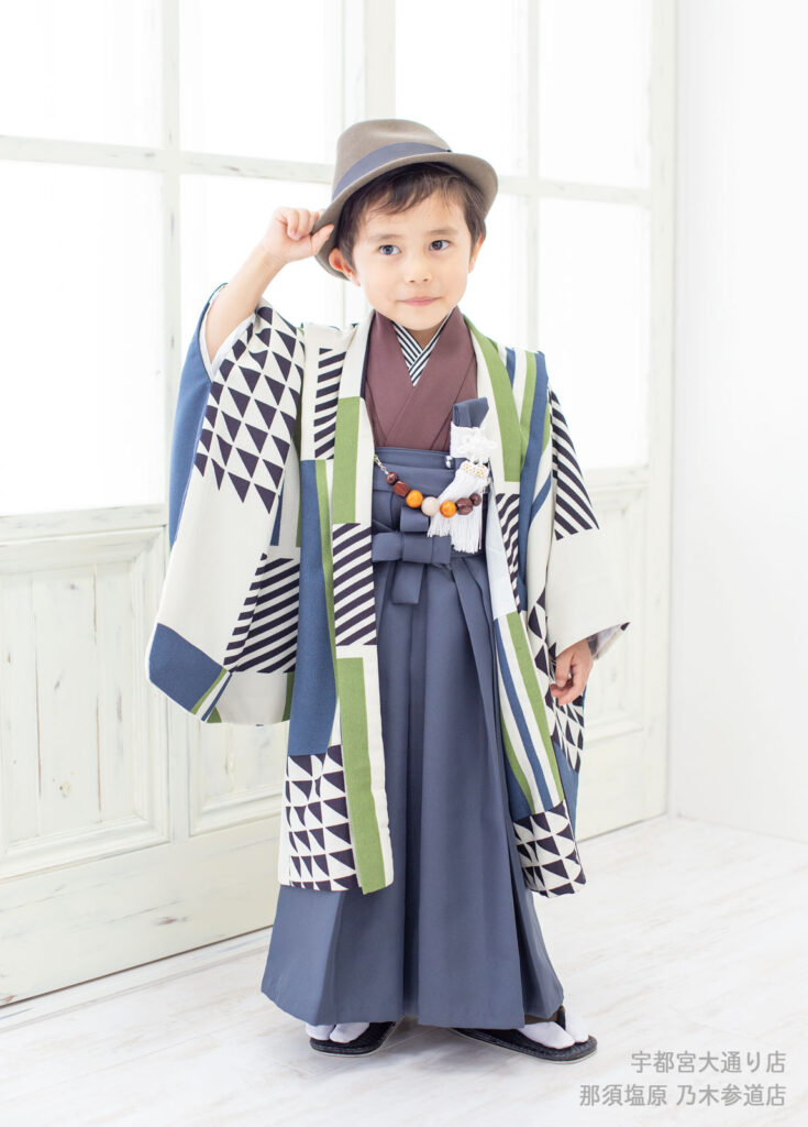 五三５歳着物：モダンな幾何学模様の着物を着てハットをかぶった５才の男の子。