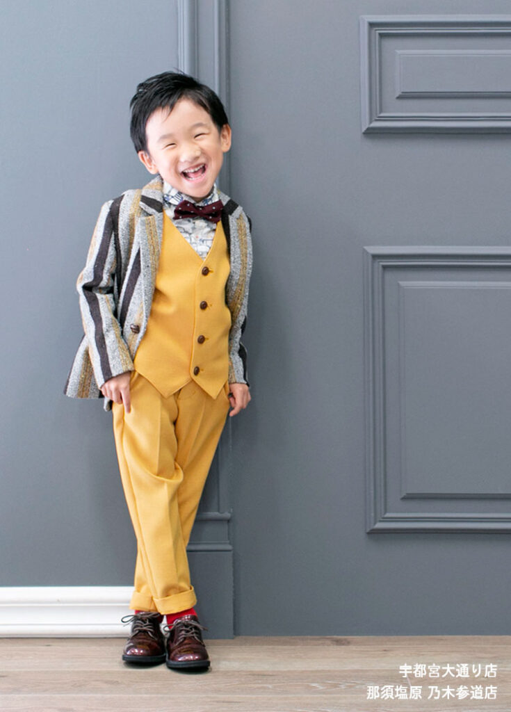 七五三５歳スーツ：マスタード色のセットアップスーツを着た5才の男の子。