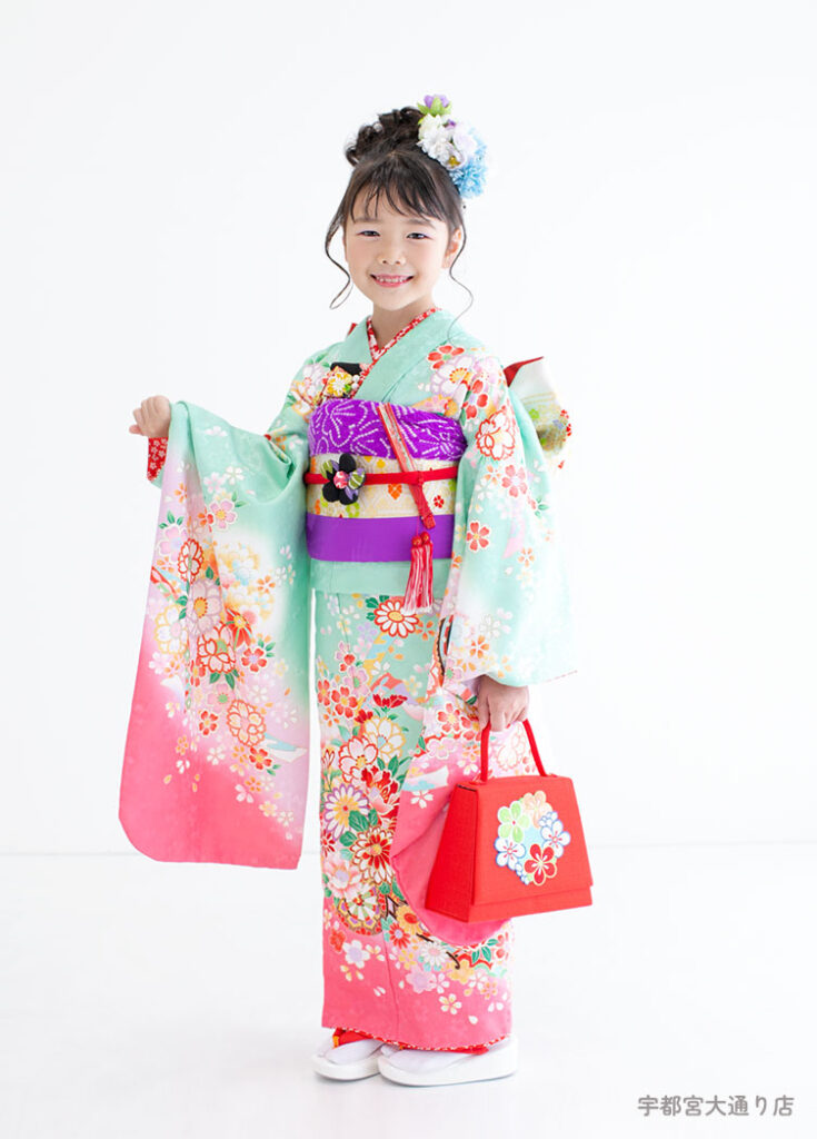 七五三７歳着物：エメラルドとピンクのグラデーション着物を着た７才の女の子。