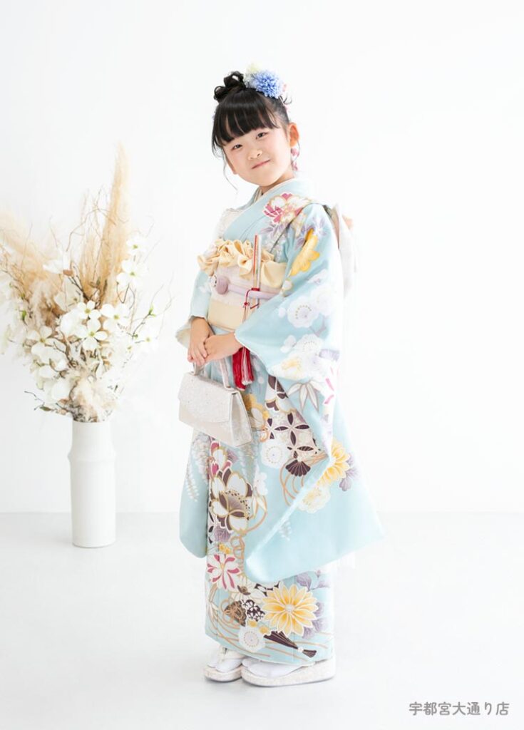 七五三７歳着物：淡い水色の古典柄の着物を着た７才の女の子。